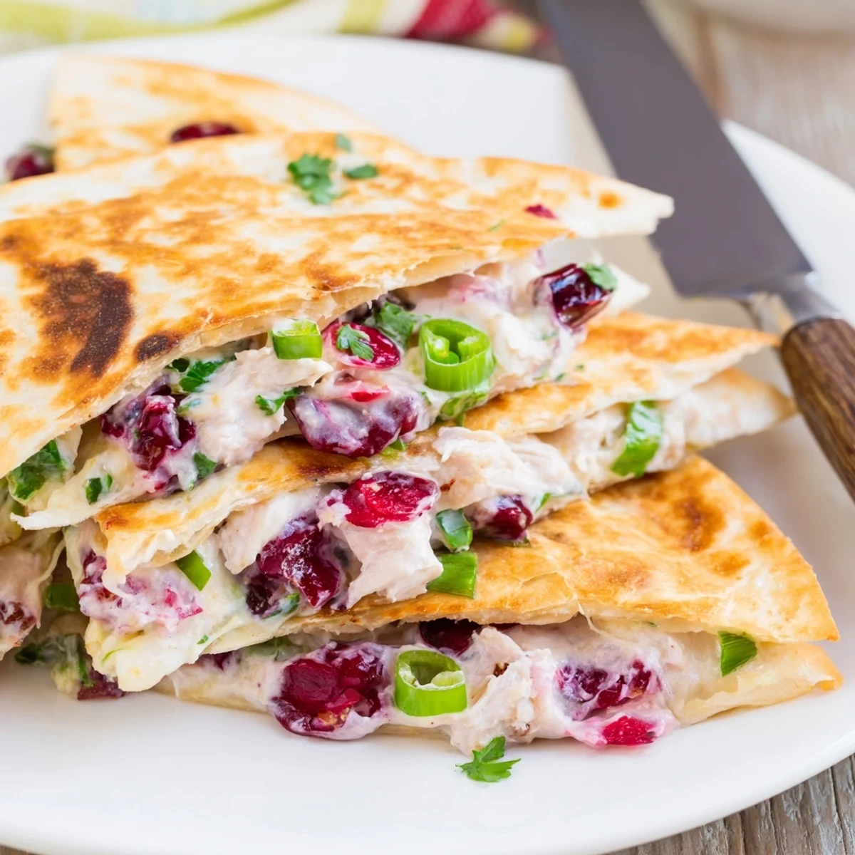 Vibrant cranberry jalapeño dip quesadillas served warm with fresh cilantro garnish.  
