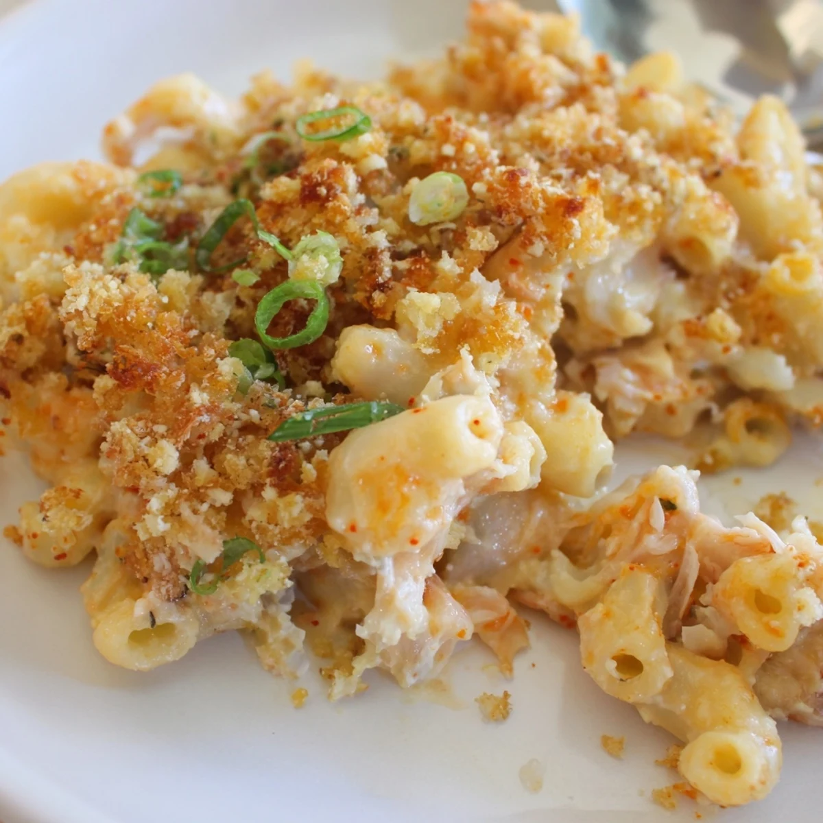 Creamy Spicy Kimchi Mac & Cheese topped with crunchy sesame and fresh spring onions.  