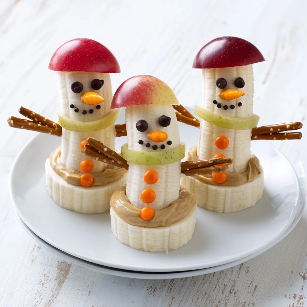 Up-close photo of festive Banana Peanut Butter Snowmen, a healthy and delightful kid-friendly food idea.