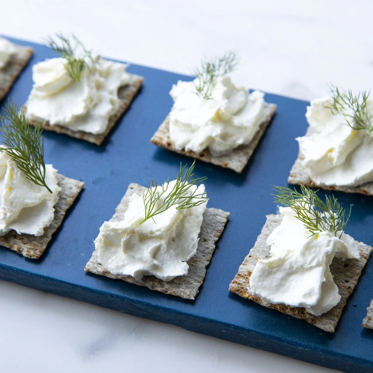 Dramatic appetizer photo of The Stormy Sea, featuring goat cheese atop charcoal crackers, perfect starter.