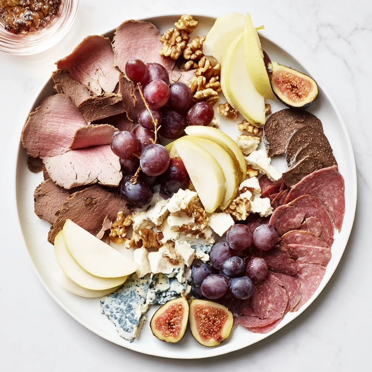 A beautiful charcuterie board, featuring sliced venison and gourmet cheeses, ready to serve.