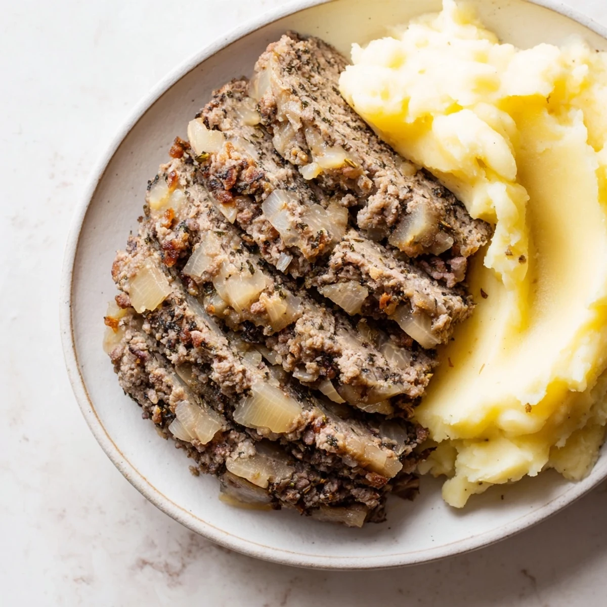 Steaming Scottish haggis, richly spiced and savory, served with creamy mashed neeps and tatties.