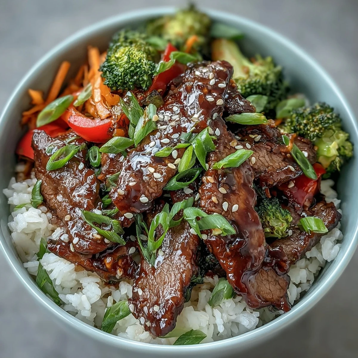 A close-up of homemade Teriyaki Beef Bowl with colorful carrots, broccoli, and bell peppers, ready to serve for dinner.