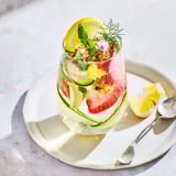 Colorful mocktails with ice, lemon slices, and strawberries, perfect for hot days.  