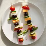 This visually appealing Double Helix Genetic Code features cheese "rungs" connecting vibrant ingredients.