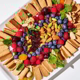 A close-up of The Picket Fence: Assorted nuts and berries inside a crunchy cracker border.