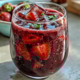 Iced Strawberry Açaí Refresher inspired by Starbucks, featuring fresh fruit, green coffee extract, and a frosty, energizing presentation.