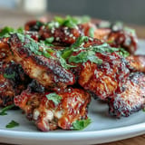 Crispy baked chicken wings coated in vibrant, fresh watermelon glaze.