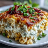 Golden baked street corn pasta bake drizzled with lime, ready to serve.