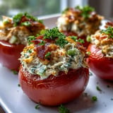 Comforting tuna melt stuffed tomatoes with melted cheddar, a perfect lunch.