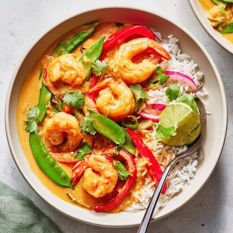 Golden Shrimp Coconut Curry Bowls with aromatic herbs, a flavorful and satisfying dinner.
