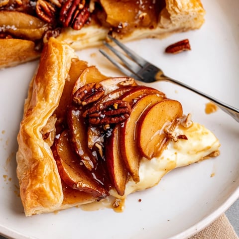Decadent Caramel Apple Brie Tart baked until golden, topped with pecans and caramel.  