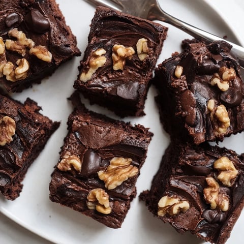 Rich Zero-Waste Brownies using nut-milk pulp, topped with chocolate chips and nuts.