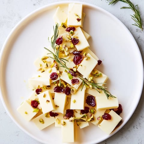 Festive Cranberry White Cheddar Tree appetizer: creamy cheddar, tart cranberries, pistachios, and rosemary arranged for holiday joy.