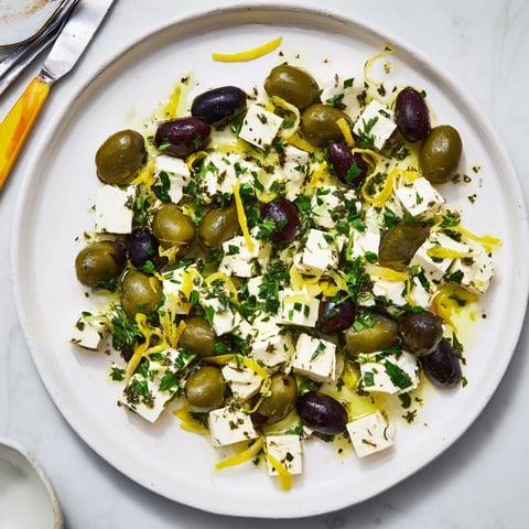 Festive Holiday Mix of mixed olives and feta cubes sprinkled with fresh parsley and zest.