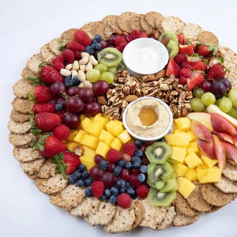 Beautiful "Hidden Oasis" appetizer showcases fresh fruits, nuts, crackers, and creamy dips for sharing.