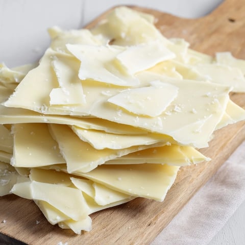 White chocolate ice sheets and parmesan shards form The Arctic Tundra dessert, stunningly presented on wood.