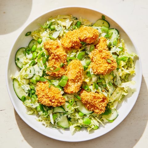 A creamy Green Goddess dressing drizzled over the crunchy Green Goddess Nugget Salad with golden nuggets.