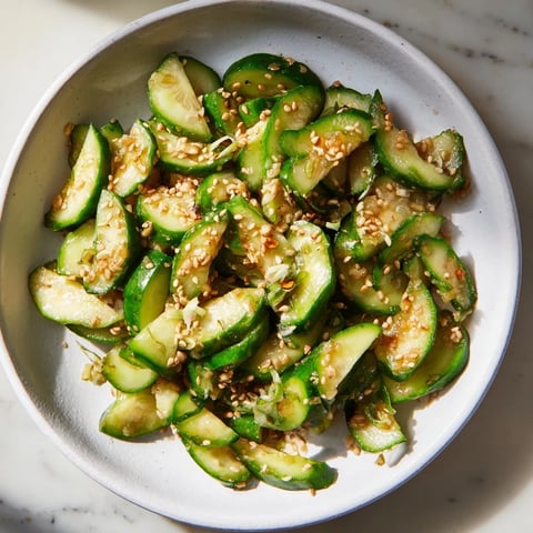 Close-up of a refreshing Cucumber Shaker salad, seasoned with rice vinegar and MSG, ready to eat.
