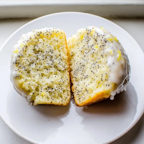Warm, golden-brown lemon poppy seed muffins, fresh from the oven, ready for a delicious breakfast.