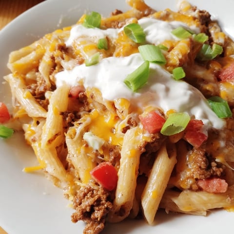 One-Pot Taco Pasta with melted cheese and fresh herbs, ready for a delicious family dinner.