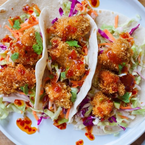 Golden, crispy Hot Honey Chicken Tacos with a vibrant slaw, drizzled in glistening, spicy honey.