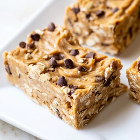 A perfect Peanut Butter Banana Oat Bar, showing a no-bake, chewy texture and delicious ingredients.