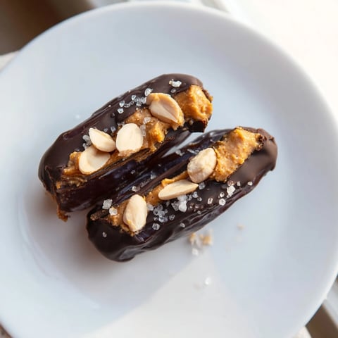Chocolate Date Snickers coated in dark chocolate with a sprinkle of sea salt look decadent.