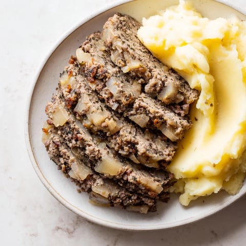 Steaming Scottish haggis, richly spiced and savory, served with creamy mashed neeps and tatties.