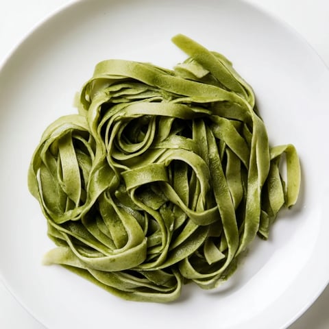 Vibrant green spinach pasta dough, ready to be rolled into delicious shapes, homemade with love.