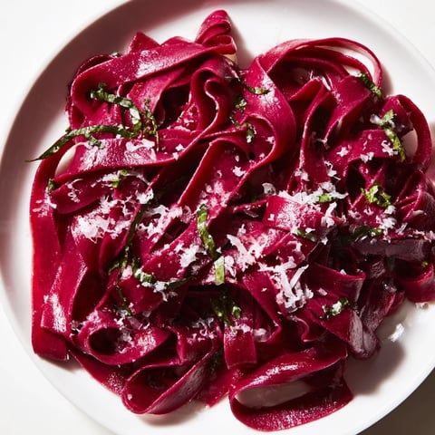 Beautiful plate of beet noodle pasta, a vibrant magenta dream, ready to be enjoyed.
