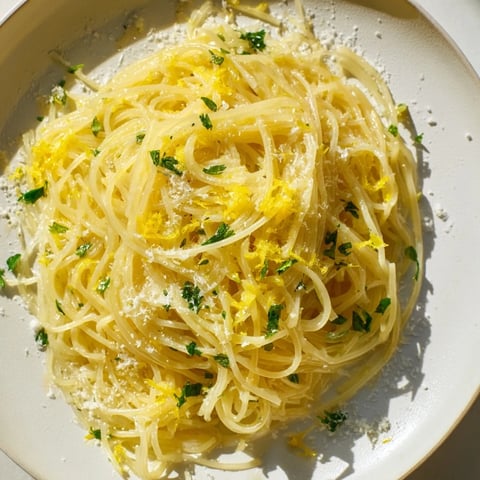 Golden, glossy Lemon Butter Pasta Light glistens from a skillet, ready to serve with fresh herbs.
