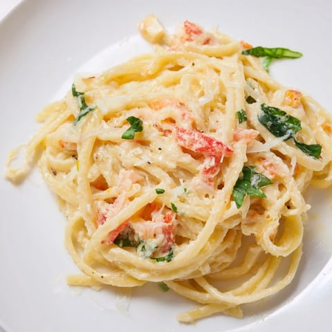 Creamy Roasted Garlic Pasta Sauce, ready on the plate with fresh basil, smells divine.