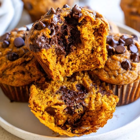 Deliciously spiced sweet potato pumpkin chocolate chip muffins cooling on a wire rack.  