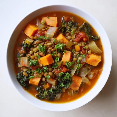 Hearty and flavorful Winter Vegetable & Lentil Soup featuring vibrant carrots and tender lentils.