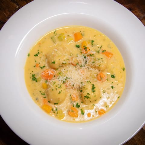 Close-up of a flavorful Savory Butternut Squash Gnocchi Soup, showcasing the tender gnocchi and veggies.