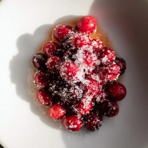 Close-up of bright red 5-Minute Express Candied Cranberries, a beautiful, crunchy topping for desserts.