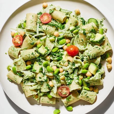 Close-up of the fresh Holiday Glow Green Goddess Protein Pasta Salad, ready to eat with herbs.