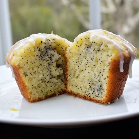 Close-up of bright, citrusy lemon poppy seed muffins, perfect for a sunny morning treat.