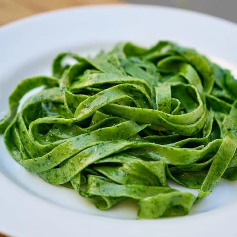 Freshly made spinach pasta dough resting before rolling, promising a beautiful Italian meal.