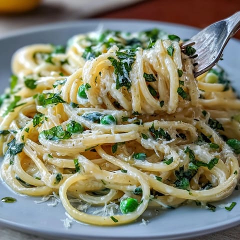 Creamy Lemon Ricotta Pasta with vibrant peas and fresh mint, ready to serve.