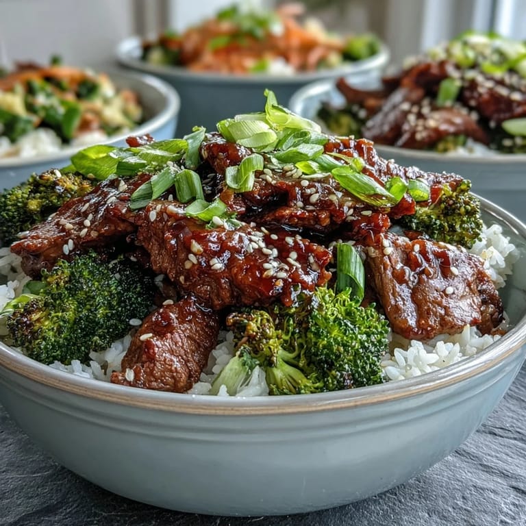 Garnished with fresh green onions and sesame seeds, this hearty Beef and Broccoli Bowl offers a satisfying, saucy weeknight dinner.
