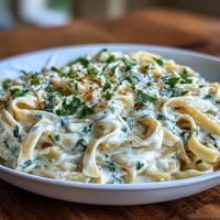 Rich, steamy Creamy Alfredo Pasta Express topped with fresh parsley and Parmesan.
