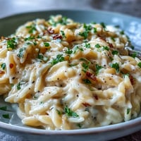 Creamy Parmesan Truffle Orzo piled high, ready for a decadent dinner.